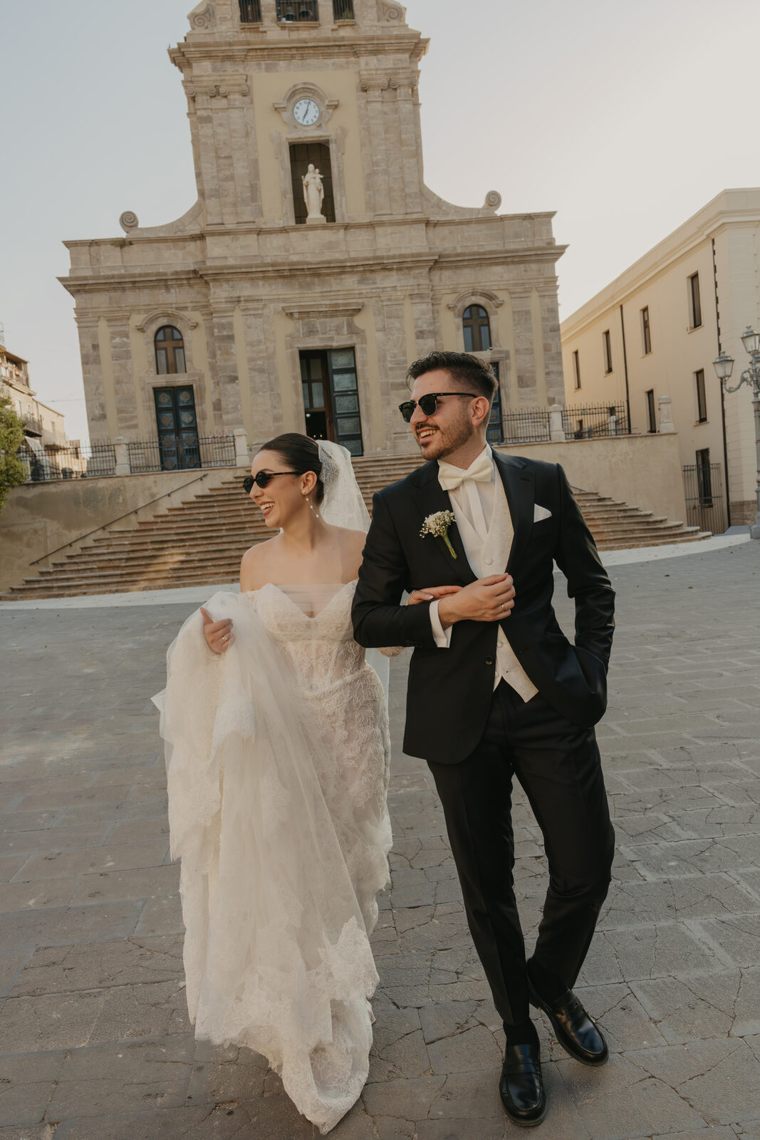 Stylish wedding couple in European city — editorial wedding photography by The Roleas