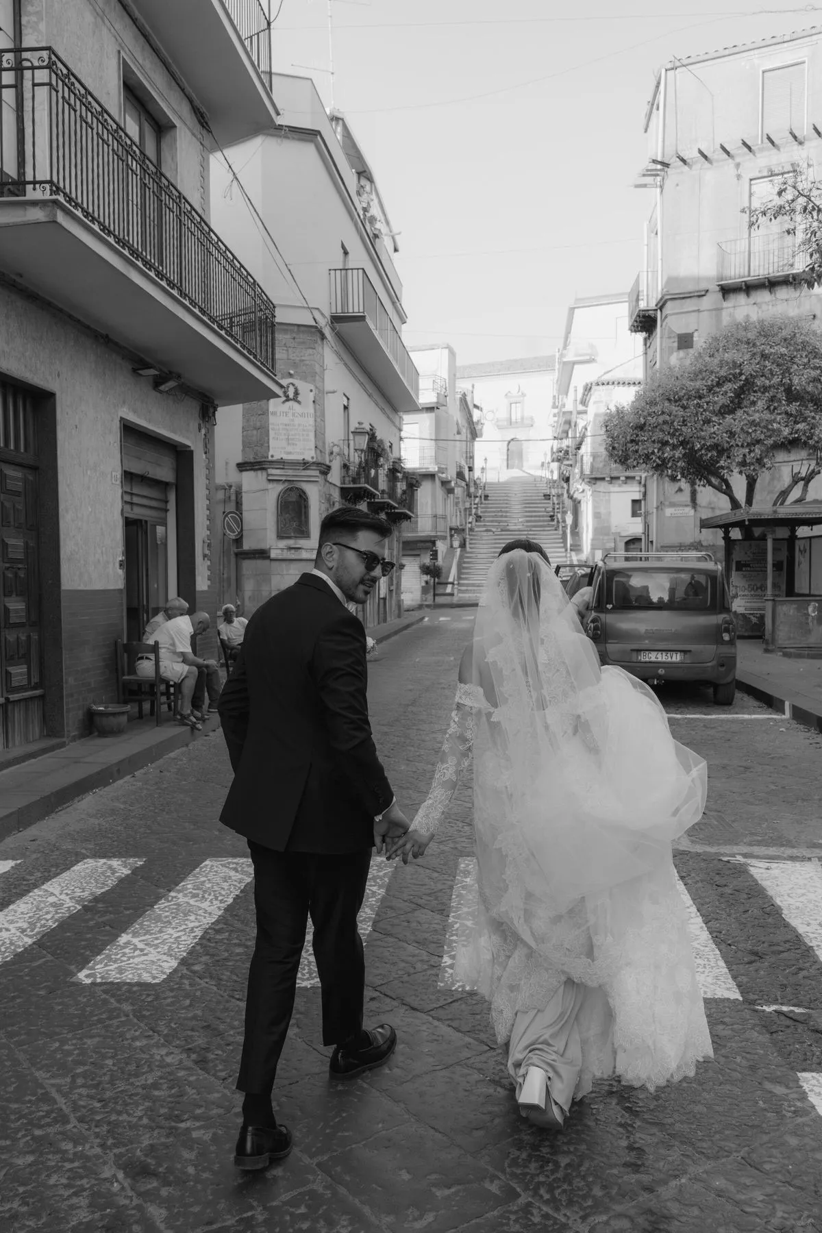 Stylish wedding couple in European city – editorial wedding photography by The Roleas